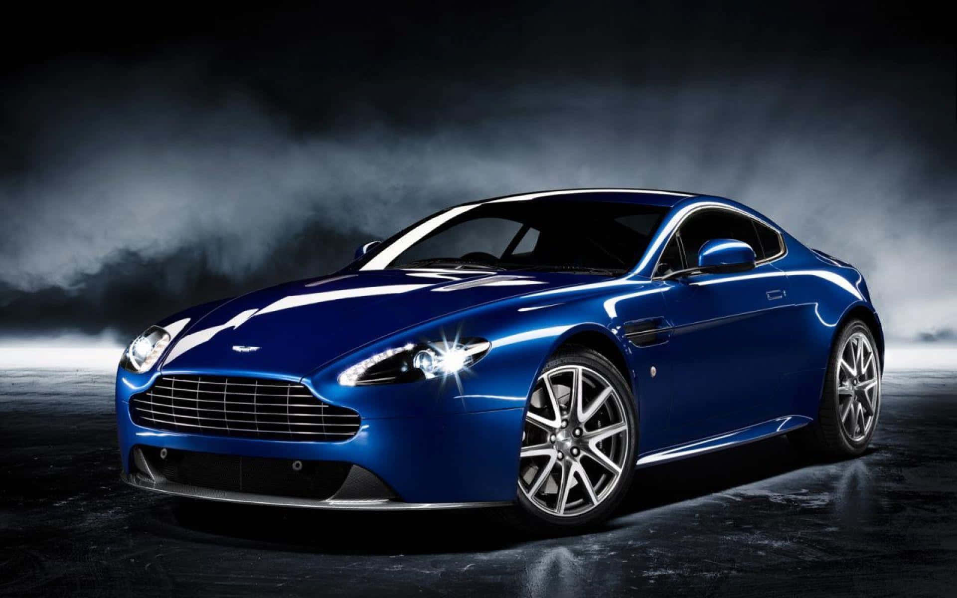경치 좋은 길 위를 달리는 멋진 Aston Martin DB9 배경화면