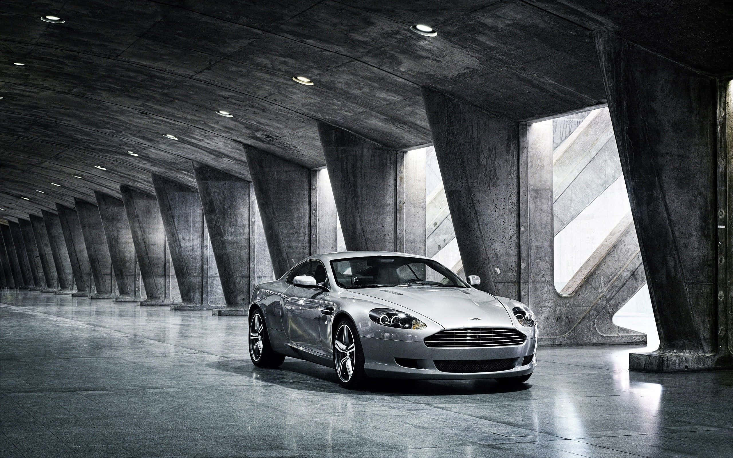 경치 좋은 도시 풍경을 달리는 Aston Martin DB9 배경화면
