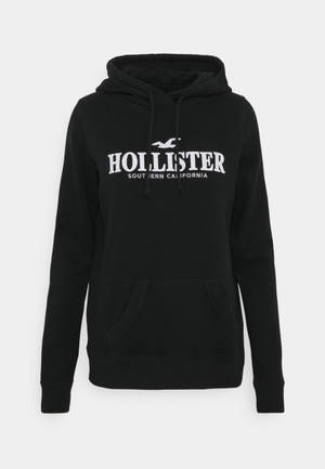 Hollister 미니멀 검은 후드 재킷 배경화면 — 깔끔한 배경화면