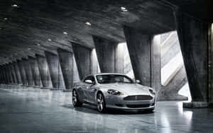 경치 좋은 도시 풍경을 달리는 Aston Martin DB9 — 스팀 덱 OLED 배경화면